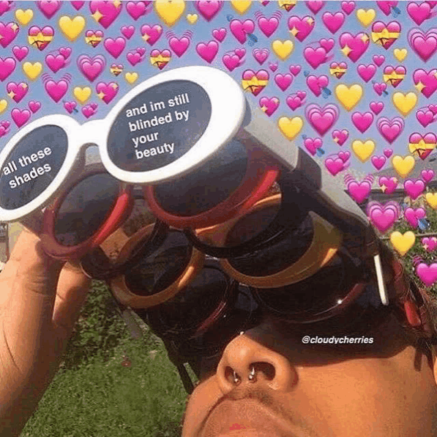 a person wearing sunglasses with a message on them that says `` and im still blinded by your beauty ''