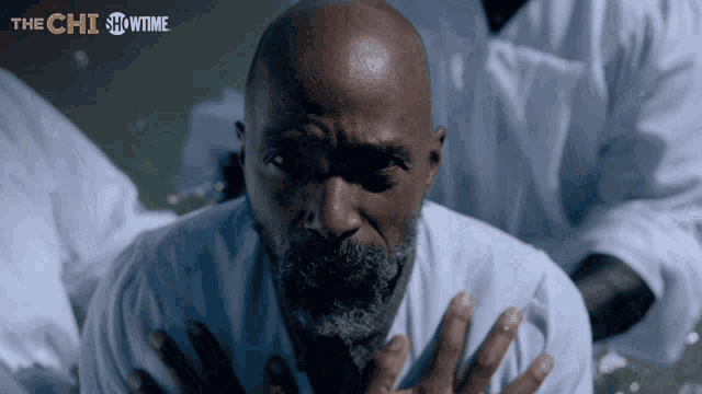 a showtime advertisement for the chi features a bald man with his hands on his chest