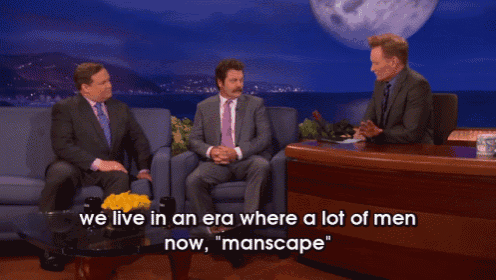 two men sitting at a table with the words " we live in an era where a lot of men now manscape "