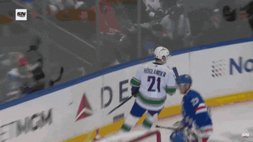 a hockey player with the number 21 on his jersey stands on the ice