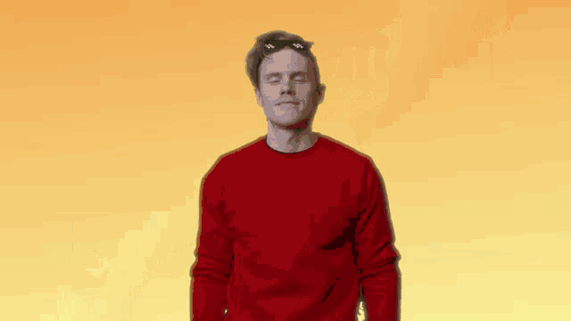 a man wearing sunglasses is standing in front of a yellow background that says ' thug life '