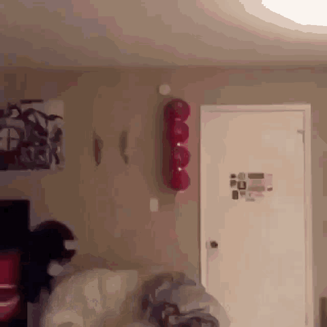 a room with a door and a balloon hanging from the wall .