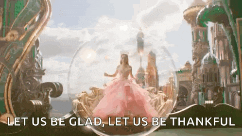 a woman in a pink dress is in a glass ball with the words let us be glad let us be thankful