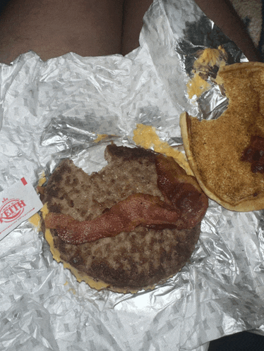 a keith sauce packet sits next to a burger