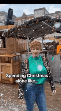 a woman is standing in front of a christmas market with the words spending christmas alone like .