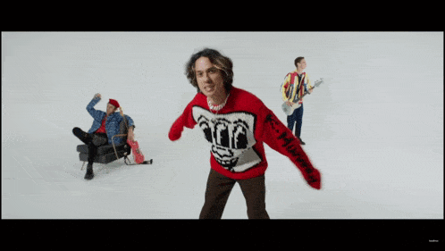 a man wearing a sweater that says ' r.i.p. ' on it