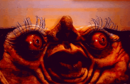 a close up of a person 's face with a very large eye