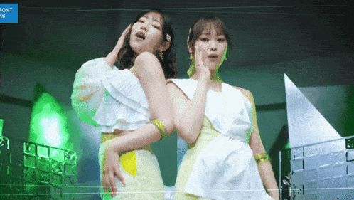 two women are standing next to each other with the word front visible