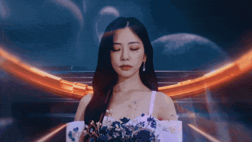 a woman with her eyes closed is holding flowers