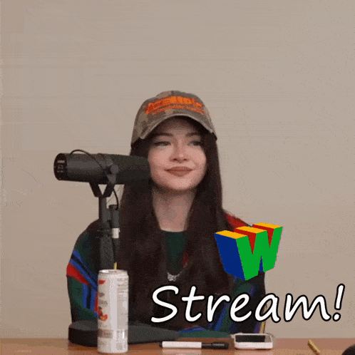 a woman sitting in front of a microphone with the words stream written on the screen
