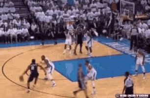 a basketball game is being played on a court with a crowd watching