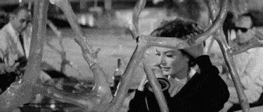 a black and white photo of a woman talking on a phone with the number 8 on it