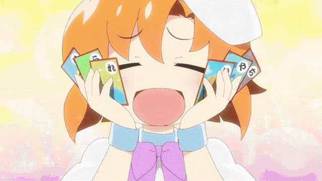 a girl with orange hair is holding a bunch of cards with the letter p on them