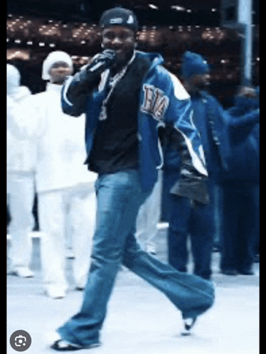 a man wearing a blue jacket that says rm on it