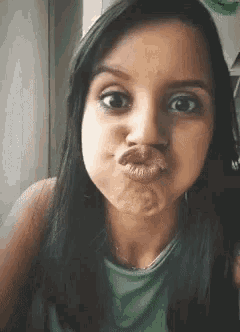 a close up of a woman making a funny face