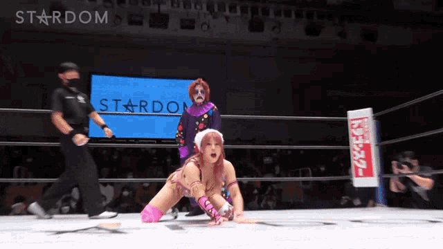 a woman in a wrestling ring with the word stardom on the screen