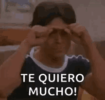 a young man is giving the middle finger and says te quiero mucho !