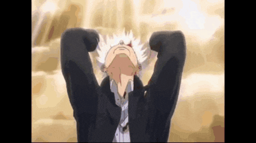 a man with white hair is standing with his hands behind his head .