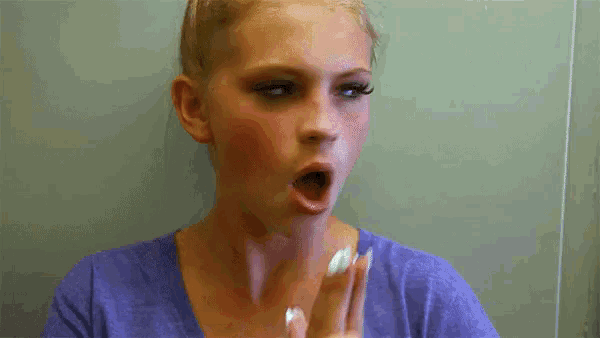 a woman in a blue shirt with her mouth open