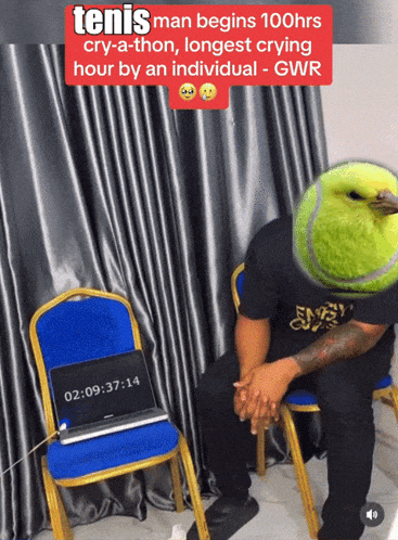 a man with a tennis ball on his head sits next to a chair