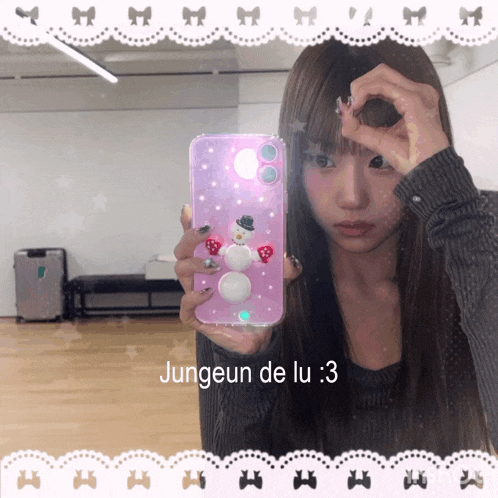 a girl taking a selfie with a phone case that says jungeun de lu