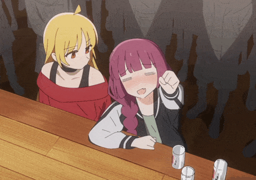 a girl with purple hair is sitting at a bar with a girl with blonde hair