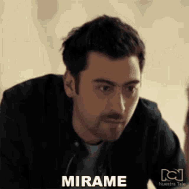 a man with a beard is making a face and says mirame