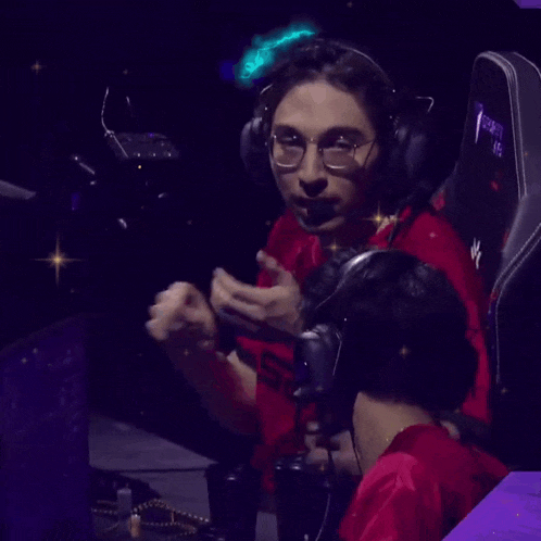 a man wearing headphones and a red shirt with the word noted on the bottom