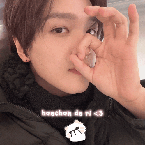 a close up of a person 's face with the words haechan de ri < 3 above it