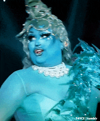 a drag queen is wearing a blue dress and pearls and has a watermark that says t4yce tumblr