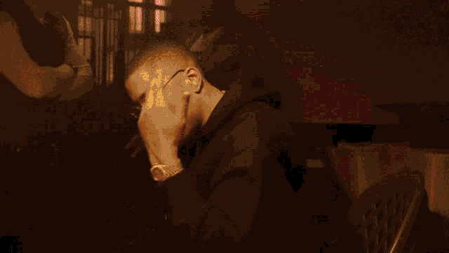 a man wearing glasses and a black hoodie with the word rash on it