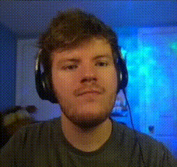 a man wearing headphones is looking at the camera with a blue background behind him .