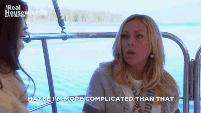 two women are sitting on a boat and one of them is saying maybe i 'm more complicated than that