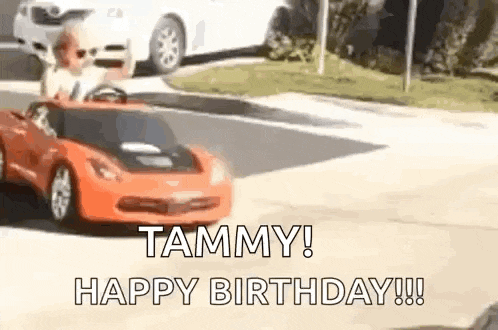 a child is driving a toy car down the street .