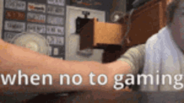 a person is holding another person 's arm with the words `` when no to gaming '' written in white letters .