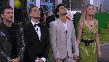 a group of people standing next to each other and looking up