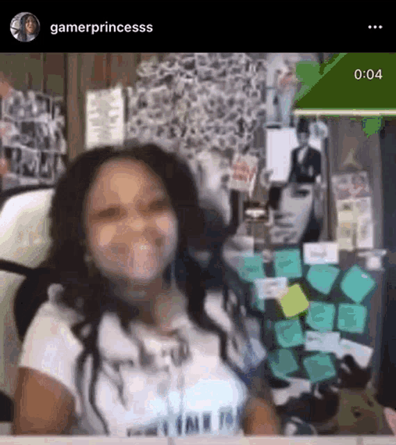 a girl is sitting in front of a desk with sticky notes on it and smiling .