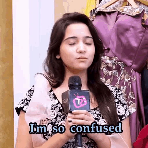 a woman holding a microphone with the words i 'm so confused above her