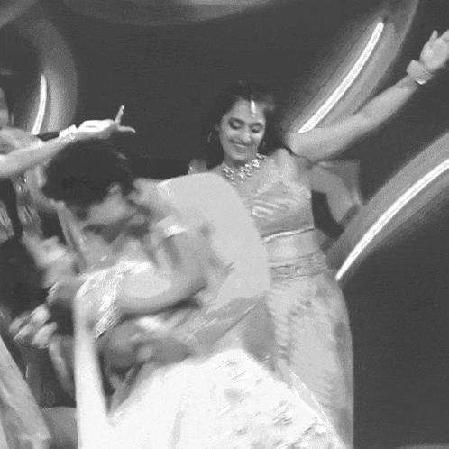 a black and white photo of a woman dancing with her arms in the air