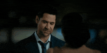 a man and woman are shaking hands on a sidewalk