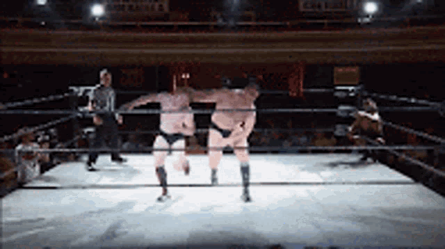 two men are wrestling in a ring with a sign that says ' gatorade '
