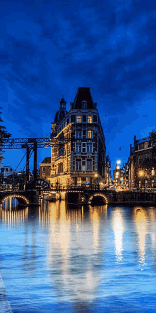 a bridge over a body of water with a building in the foreground