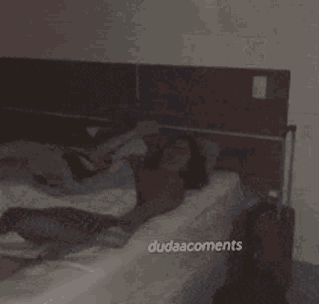 a woman is laying on a bed with the words dudaacomments written on the bottom