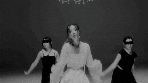a woman in a white dress is being held by a man in a black dress