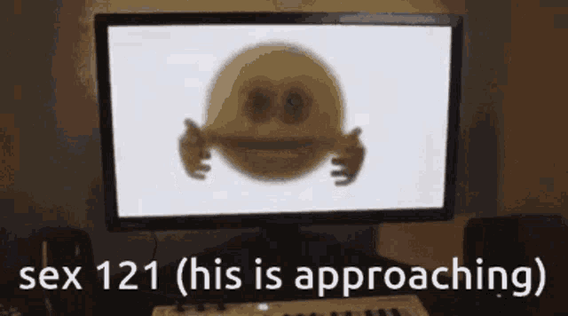 a computer monitor with a smiley face on it and the text sex 121 ( his is approaching )