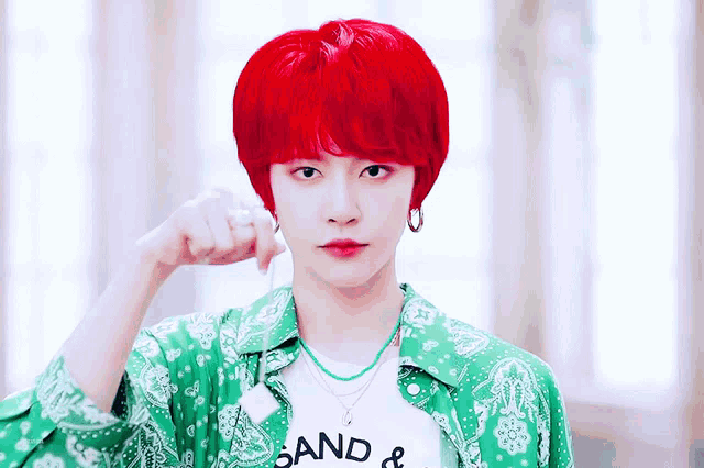 a person with red hair is wearing a shirt that says sand