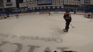 a hockey game is being played in a stadium with a sign that says alaska on it