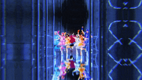 a group of people are dancing in a tunnel with a blue background