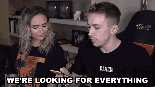 a man and a woman are looking at a cell phone with the words " we 're looking for everything " above them