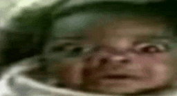 a close up of a baby 's face with a serious look on it 's face
